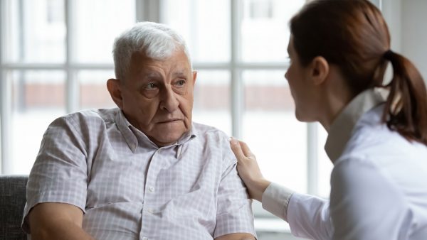 Elderly man getting bad news from his doctor